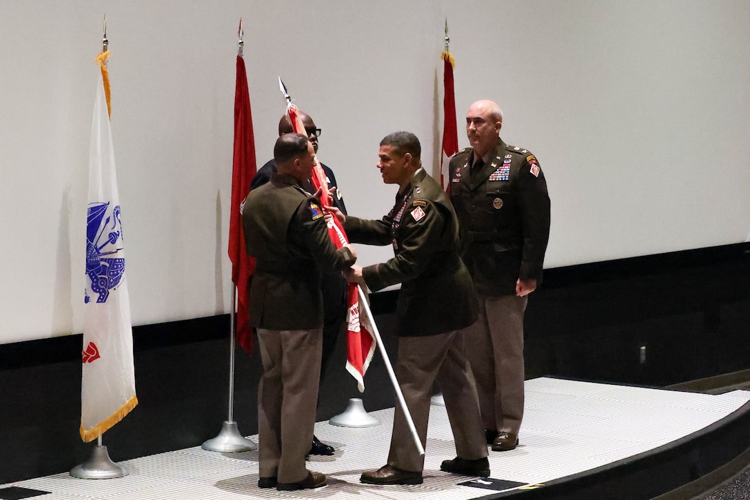 At the U.S. Army Engineering and Support Center, Huntsville Change of Command, Deputy Commanding General for Military and International Operations, Headquarters U.S. Army Corps of Engineers, Maj. Gen. Mark Quander, passes the guidon to incoming commander, Col. Robert Hilliard, U.S. Space and Rocket Center’s Davidson Center for Space Exploration, 1 Tranquility Base, Huntsville, Alabama.