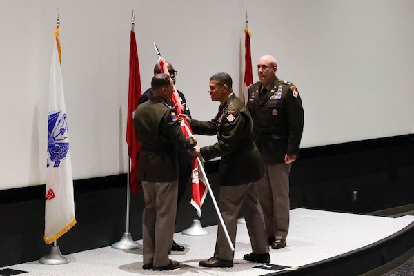 At the U.S. Army Engineering and Support Center, Huntsville Change of Command, Deputy Commanding General for Military and International Operations, Headquarters U.S. Army Corps of Engineers, Maj. Gen. Mark Quander, passes the guidon to incoming commander, Col. Robert Hilliard, U.S. Space and Rocket Center’s Davidson Center for Space Exploration, 1 Tranquility Base, Huntsville, Alabama.