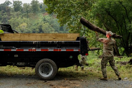 A U.S. Soldier with the District of Columbia Army National Guard tosses a log into the back of a truck during a cleanup at Fletcher's Cove in support of Task Force Beautification Washington, D.C., Sept. 17, 2025. About 2,300 National Guard members are supporting the D.C. Safe and Beautiful mission providing critical support to the D.C. Metropolitan Police Department in ensuring the safety of all who live, work and visit the District.
