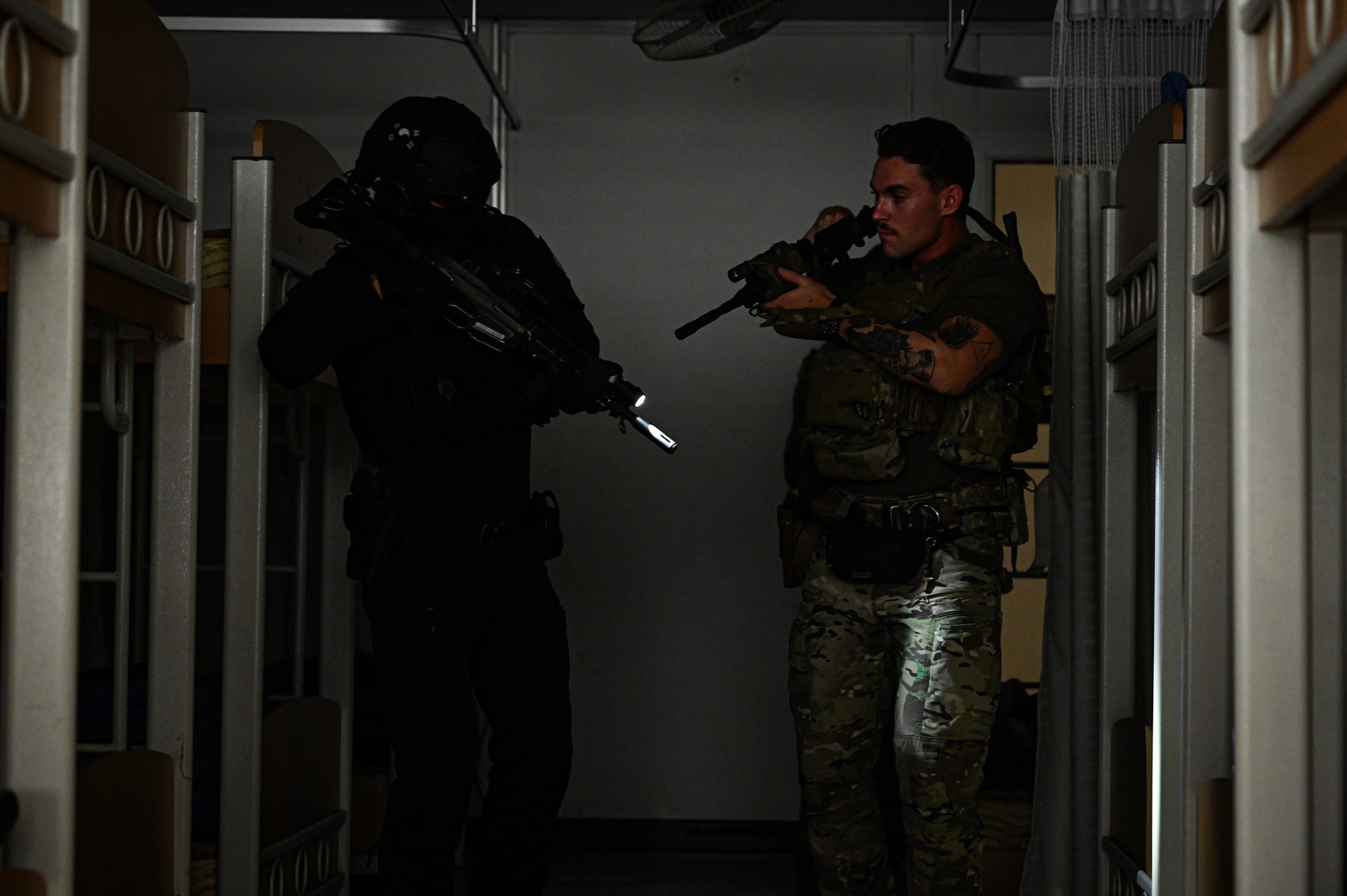 A U.S. Air Force Airman from the 11th Combat Air Base Squadron and a security forces member from the Republic of Korea air force clear a bunkhouse during exercise Ulchi Freedom Shield 25 at Daegu Air Base, Republic of Korea, Aug. 21, 2025. UFS 25 is a defense-oriented exercise focused on fortifying response capabilities to safeguard security on the peninsula. (U.S. Air Force photo by Senior Airman Andrew Garavito)