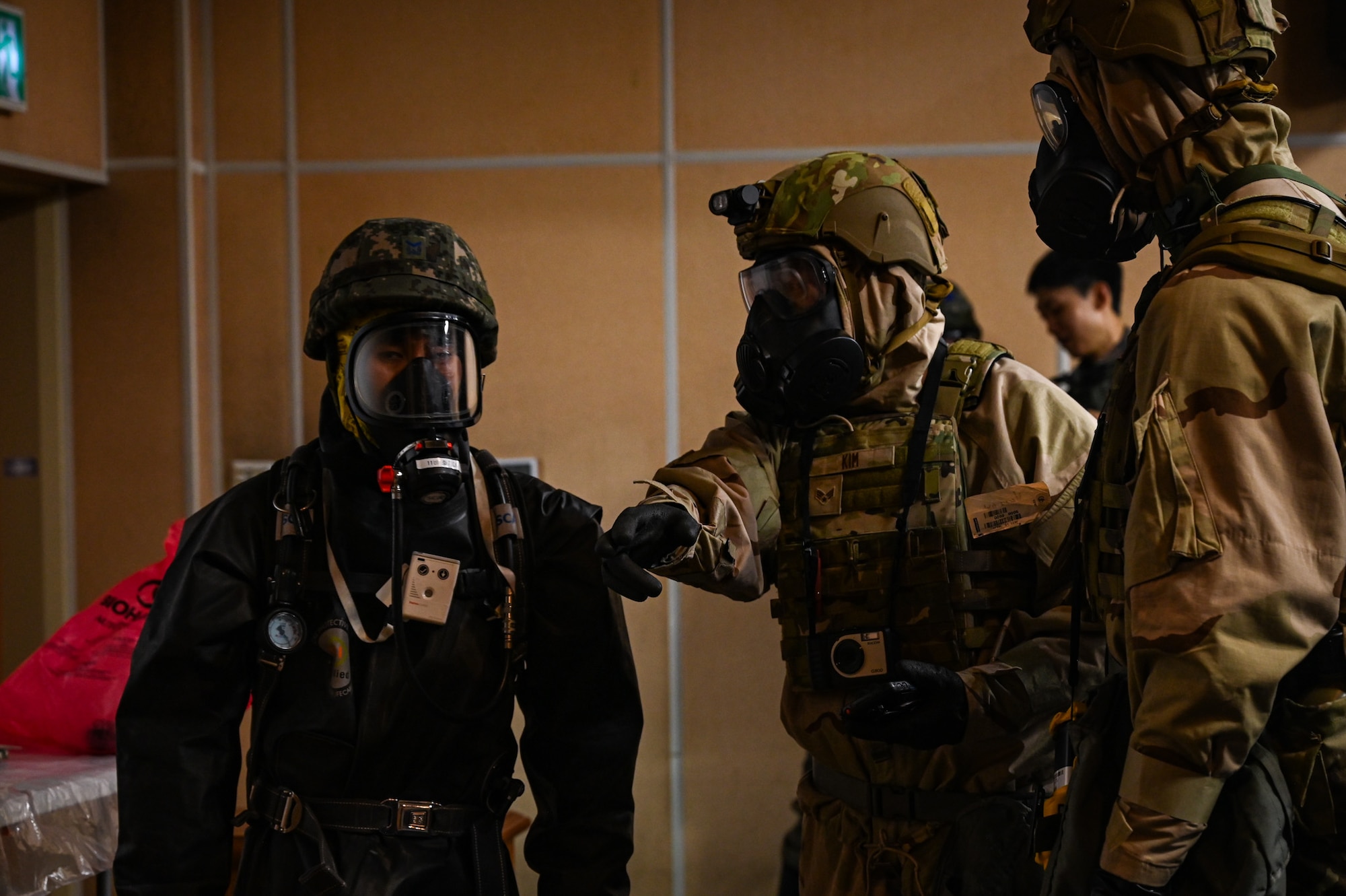 U.S. Air Force Airmen from the 11th Combat Air Base Squadron communicate chemical, biological, radiological and nuclear protocols to a member of the Republic of Korea air force during integrated training at Daegu Air Base, Republic of Korea, Sept. 4, 2025. The 11 CABS has the ability to establish expeditionary locations to deliver command and control and base operating support–integration in support of Department of Defense priorities around the world. (U.S. Air Force photo by Senior Airman Andrew Garavito)