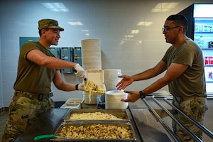 A U.S. Air Force Airman from the 11th Combat Air Base Squadron serves food to a customer during exercise Ulchi Freedom Shield 25 at Daegu Air Base, Republic of Korea, Aug. 21, 2025. UFS 25 provides a rigorous training environment to enhance combat readiness and response capabilities. (U.S. Air Force photo by Senior Airman Andrew Garavito)