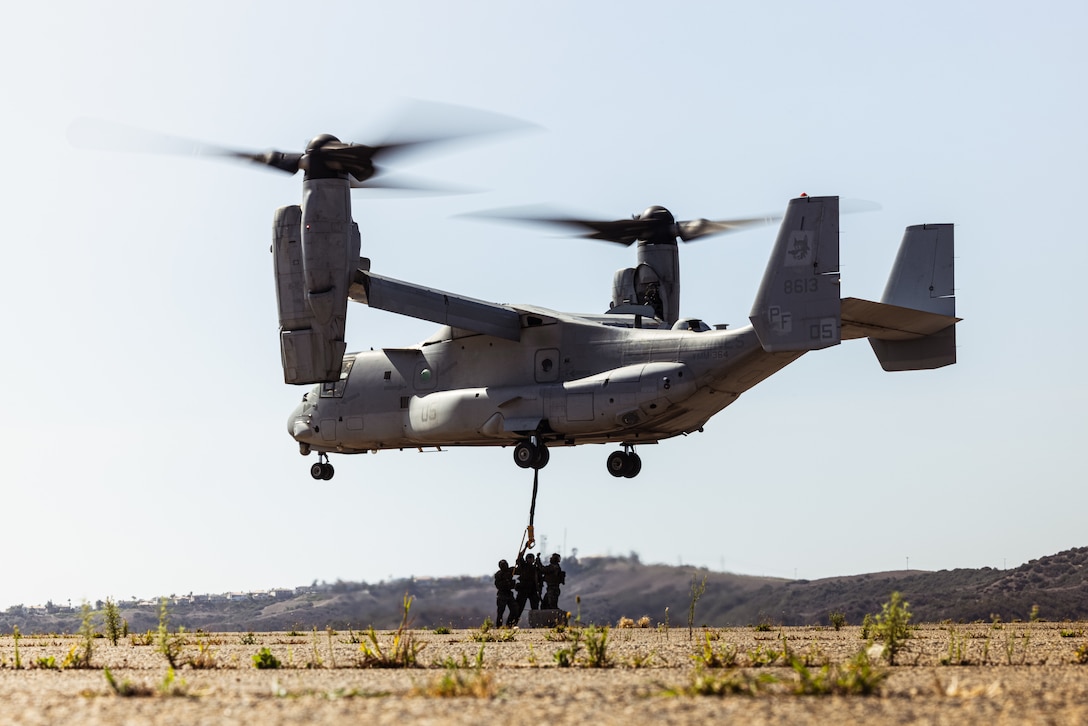 U.S. Marines with 1st Distribution Support Battalion, Combat Logistics Regiment 1, 1st Marine Logistics Group, sling load a concrete black onto an MV-22B Osprey during helicopter support team operations on Marine Corps Base Camp Pendleton, California, Sept. 30, 2025.