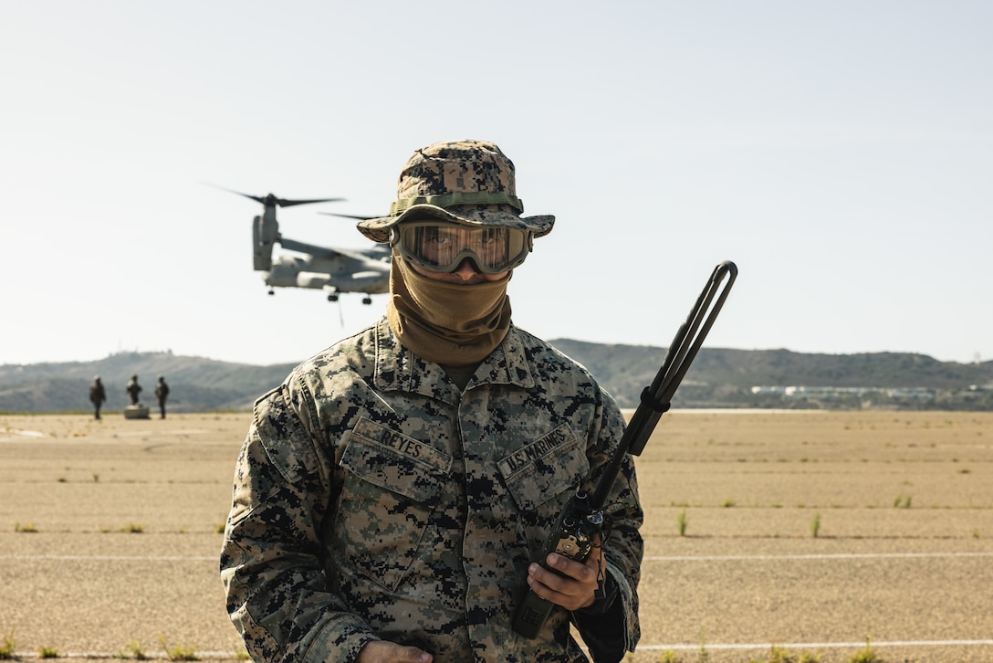 U.S. Marine Corps Cpl. Noah Reyes, a logistics specialist with 1st Distribution Support Battalion, Combat Logistics Regiment 1, 1st Marine Logistics Group, supervises an external lift during helicopter support team operations on Marine Corps Base Camp Pendleton, California, Sept. 30, 2025.