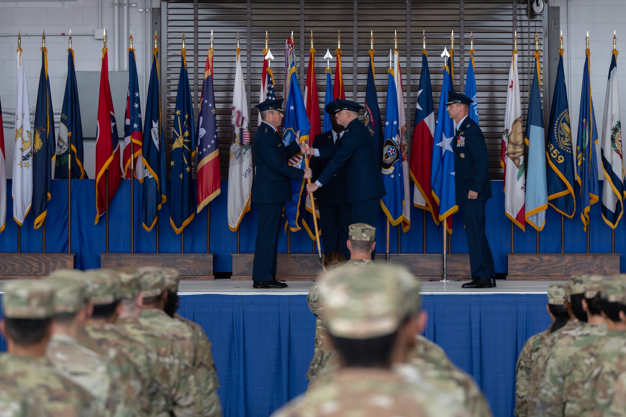 Lt. Gen. Michael Conley, commander of Air Force Special Operations Command, hands the 1st Special Operations Wing guidon to Col. Mark Hamilton during a change of command ceremony at Hurlburt Field, Florida, Oct. 6, 2025.