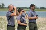 A photo of natural resources specialists searching for piping plover.