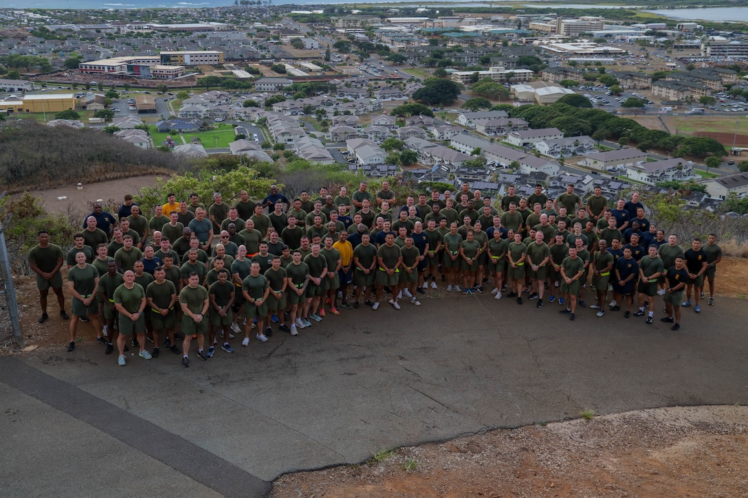 U.S. Marine Corps staff noncommissioned officers with Marine Aircraft Group 24, 1st Marine Aircraft Wing, pose for a photo after climbing Kansas Tower Hill at Marine Corps Base Hawaii, Oct. 1, 2025. This event enhanced physical and mental fitness with a three-mile run that concluded with a discussion about what it means to serve as a senior enlisted leader in the U.S. Marine Corps. (U.S. Marine Corps photo by Lance Cpl. Chandler Evans)