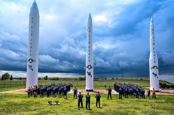 Airmen from the 90th Medical Group at F.E. Warren AFB pose for a group photo in front of a historical static display