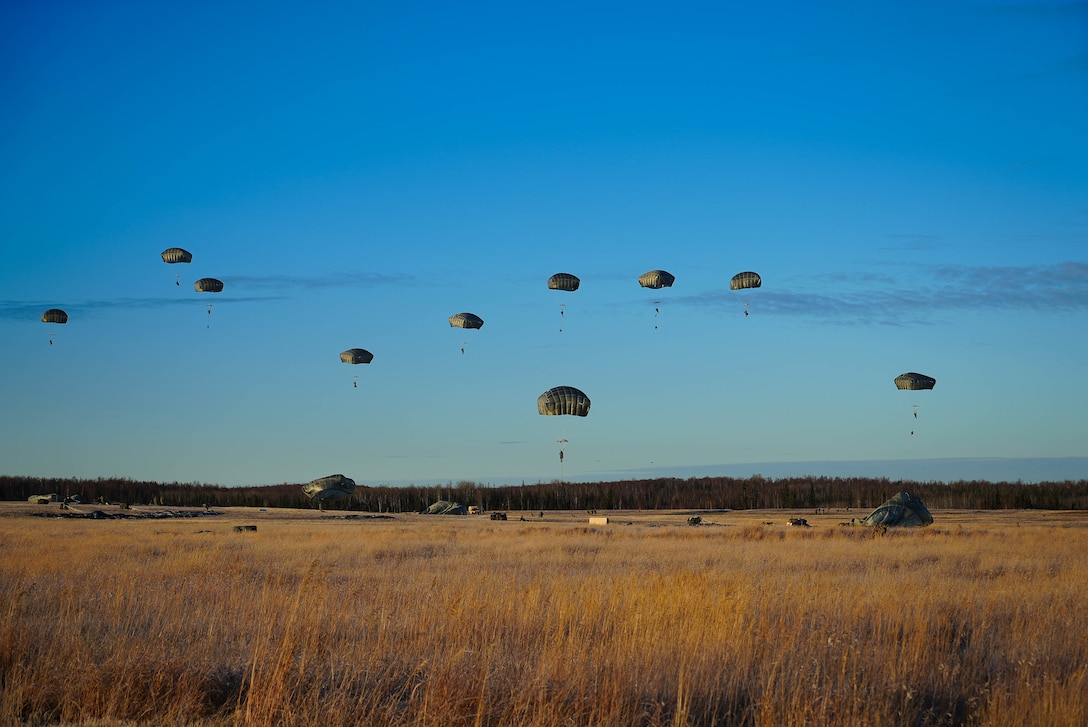 U.S. Army soldiers assigned to 2nd Infantry Brigade Combat Team (Airborne), 11th Airborne Division, descend from the sky onto Malamute Drop Zone on Joint Base Elmendorf-Richardson, Alaska for Arctic Aloha Oct. 15, 2024.