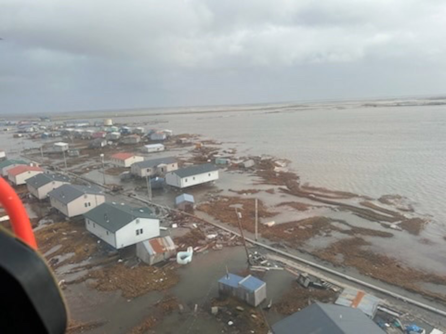 U.S. Coast Guard MH-60 Jayhawk helicopter aircrews conduct overflights of Kipnuk, Alaska, after coastal flooding impacted several western Alaska communities, Oct. 12, 2025.