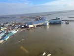 U.S. Coast Guard MH-60 Jayhawk helicopter aircrews conduct overflights of Kipnuk, Alaska, after coastal flooding impacted several western Alaska communities, Oct. 12, 2025.
