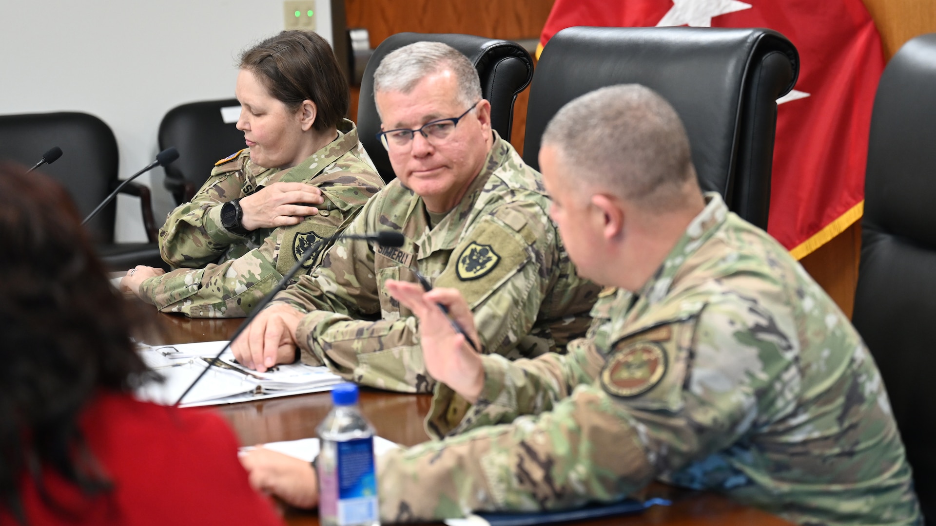 Two generals speak at a conference table.