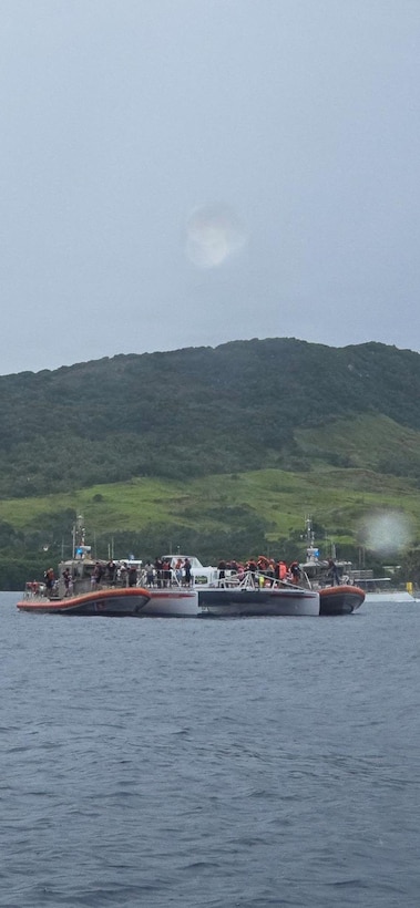 Coast Guard 45-foot Response Boat-Medium crews from Station Apra Harbor assist passengers aboard the Princess Guam, a disabled passenger vessel off Agat, Guam, Oct. 10, 2025. Coast Guard watchstanders received a notification on VHF-FM channel 16 from the vessel’s crew reporting smoke coming from the engine compartment and that 45 people were aboard. (U.S. Coast Guard photo, courtesy Station Apra Harbor)