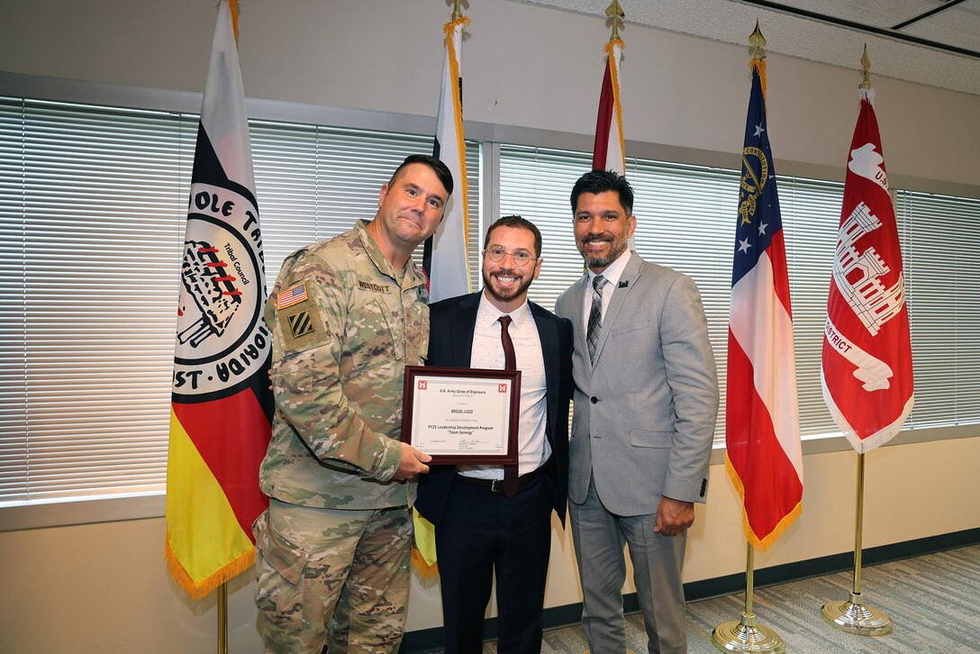 (Left to Right) Maj. Matt Westoctt, Jacksonville District Deputy Commander, Anthony Tallie and Howie Gonzalez, Jacksonville District Deputy District Engineer for Programs and Project Management present awards at the U.S. Army Corps of Engineers Jacksonville District completion and graduation of the 2025 Leadership Development Program Course during a ceremony at district headquarters at the Prudential Building on Jacksonville’s Southbank. (USACE photo by Bri Sanchez)