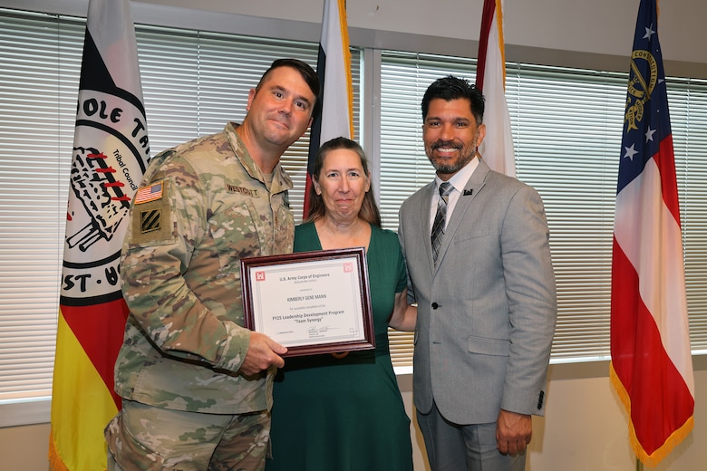 (Left to Right) Maj. Matt Westoctt, Jacksonville District Deputy Commander, Anthony Tallie and Howie Gonzalez, Jacksonville District Deputy District Engineer for Programs and Project Management present awards at the U.S. Army Corps of Engineers Jacksonville District completion and graduation of the 2025 Leadership Development Program Course during a ceremony at district headquarters at the Prudential Building on Jacksonville’s Southbank. (USACE photo by Bri Sanchez)