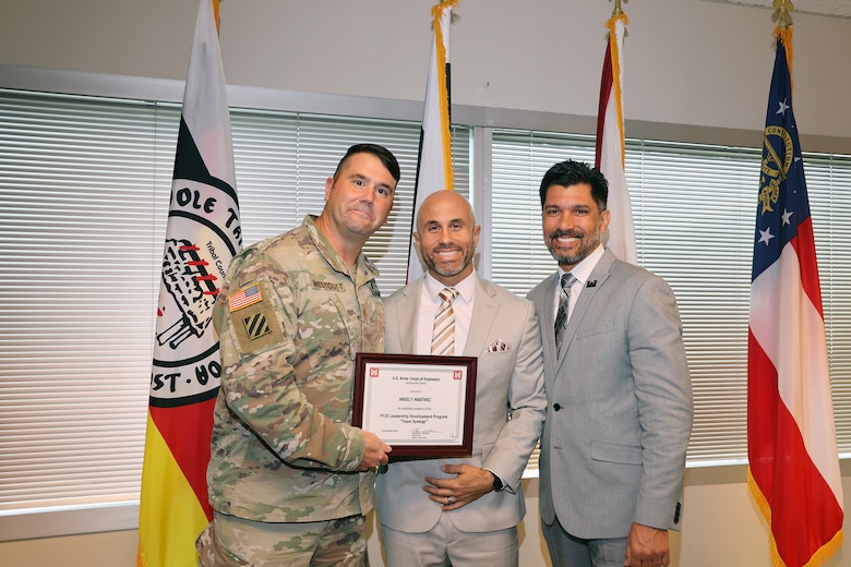 (Left to Right) Maj. Matt Westoctt, Jacksonville District Deputy Commander, Anthony Tallie and Howie Gonzalez, Jacksonville District Deputy District Engineer for Programs and Project Management present awards at the U.S. Army Corps of Engineers Jacksonville District completion and graduation of the 2025 Leadership Development Program Course during a ceremony at district headquarters at the Prudential Building on Jacksonville’s Southbank. (USACE photo by Bri Sanchez)