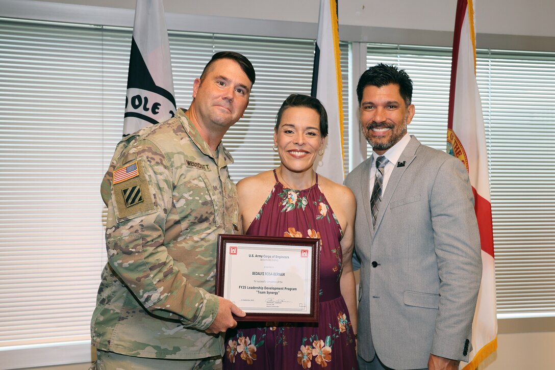 (Left to Right) Maj. Matt Westoctt, Jacksonville District Deputy Commander, Anthony Tallie and Howie Gonzalez, Jacksonville District Deputy District Engineer for Programs and Project Management present awards at the U.S. Army Corps of Engineers Jacksonville District completion and graduation of the 2025 Leadership Development Program Course during a ceremony at district headquarters at the Prudential Building on Jacksonville’s Southbank. (USACE photo by Bri Sanchez)
