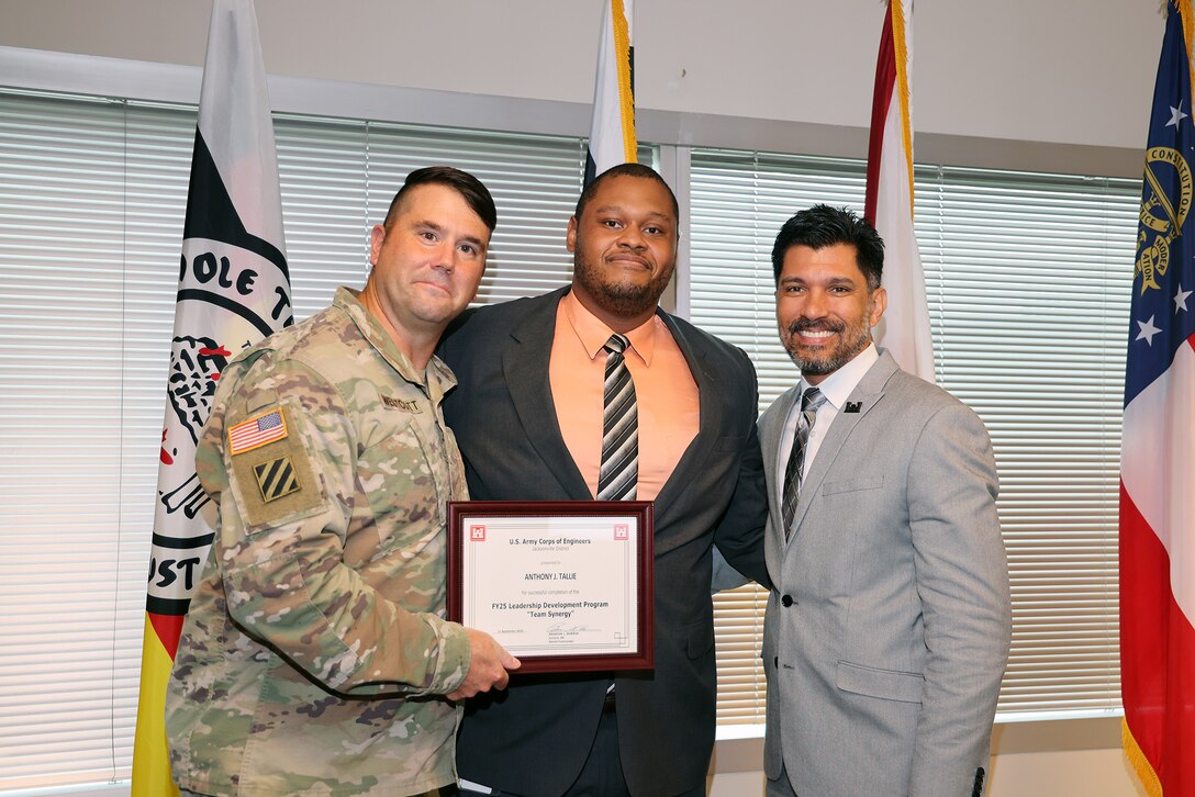 (Left to Right) Maj. Matt Westoctt, Jacksonville District Deputy Commander, Anthony Tallie and Howie Gonzalez, Jacksonville District Deputy District Engineer for Programs and Project Management present awards at the U.S. Army Corps of Engineers Jacksonville District completion and graduation of the 2025 Leadership Development Program Course during a ceremony at district headquarters at the Prudential Building on Jacksonville’s Southbank. (USACE photo by Bri Sanchez)