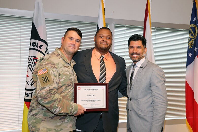 (Left to Right) Maj. Matt Westoctt, Jacksonville District Deputy Commander, Anthony Tallie and Howie Gonzalez, Jacksonville District Deputy District Engineer for Programs and Project Management present awards at the U.S. Army Corps of Engineers Jacksonville District completion and graduation of the 2025 Leadership Development Program Course during a ceremony at district headquarters at the Prudential Building on Jacksonville’s Southbank. (USACE photo by Bri Sanchez)