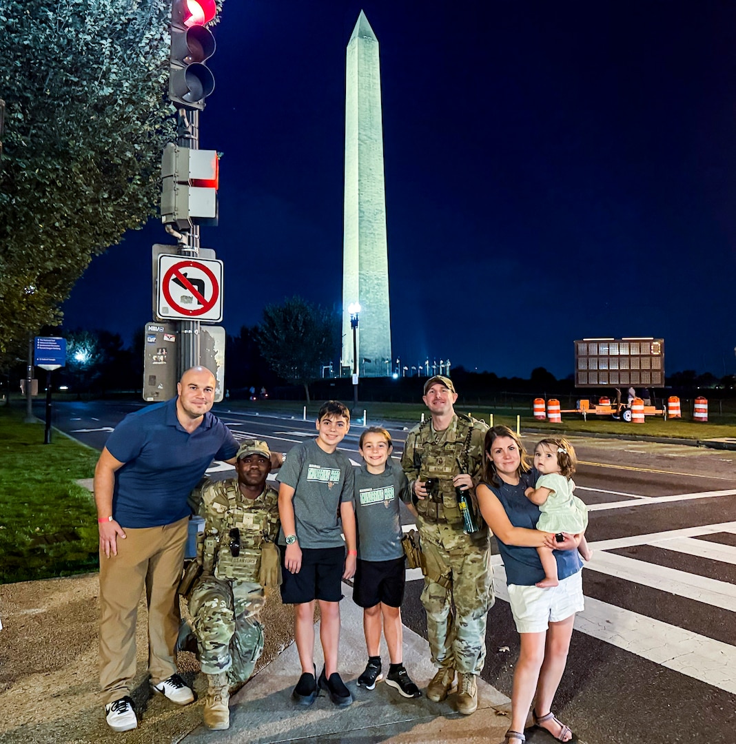 U.S. Air Force Airman Devontae Taylor, left, and Tech. Sgt. Richard Kramer, right, Airmen with the 172nd Airlift Wing, Mississippi National Guard, with the 112th Military Police Battalion, Mississippi National Guard, Task Force Magnolia, pose for a photo with the family they assisted in recovering their lost child near the Washington Monument, Washington, D.C., Oct. 6, 2025. About 2,300 National Guard members are supporting the D.C. Safe and Beautiful mission providing critical support to the D.C. Metropolitan Police Department in ensuring the safety of all who live, work and visit the District.