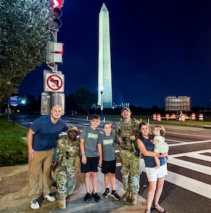 U.S. Air Force Airman Devontae Taylor, left, and Tech. Sgt. Richard Kramer, right, Airmen with the 172nd Airlift Wing, Mississippi National Guard, with the 112th Military Police Battalion, Mississippi National Guard, Task Force Magnolia, pose for a photo with the family they assisted in recovering their lost child near the Washington Monument, Washington, D.C., Oct. 6, 2025. About 2,300 National Guard members are supporting the D.C. Safe and Beautiful mission providing critical support to the D.C. Metropolitan Police Department in ensuring the safety of all who live, work and visit the District.