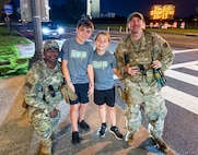 U.S. Air Force Airman Devontae Taylor, left, and Tech. Sgt. Richard Kramer, Airmen with the 172nd Airlift Wing, Mississippi National Guard, with the 112th Military Police Battalion, Mississippi National Guard, Task Force Magnolia, recovered a lost child, center left, near the Washington Monument, Washington, D.C., Oct. 6, 2025. About 2,300 National Guard members are supporting the D.C. Safe and Beautiful mission providing critical support to the D.C. Metropolitan Police Department in ensuring the safety of all who live, work and visit the District.