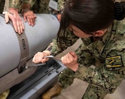 A sailor assigned to the Commanding Officer, Mobile Mine Assembly Group (CONOMAG), trains on a Quickstrike Extended Range (QS-ER) mine as part of Underwater Mine Personnel Qualification Standard Working Group held at Naval Surface Warfare Center Panama City Division. CONOMOG, as well as the Navy Munitions Command Unit Charleston, were the two activities that represented fleet personnel during the event.