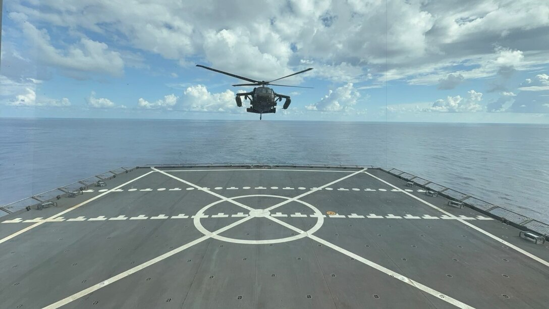 A UH-60 Black Hawk helicopter approaches the deck of the USNS Robert Kennedy ship in preparation to land.