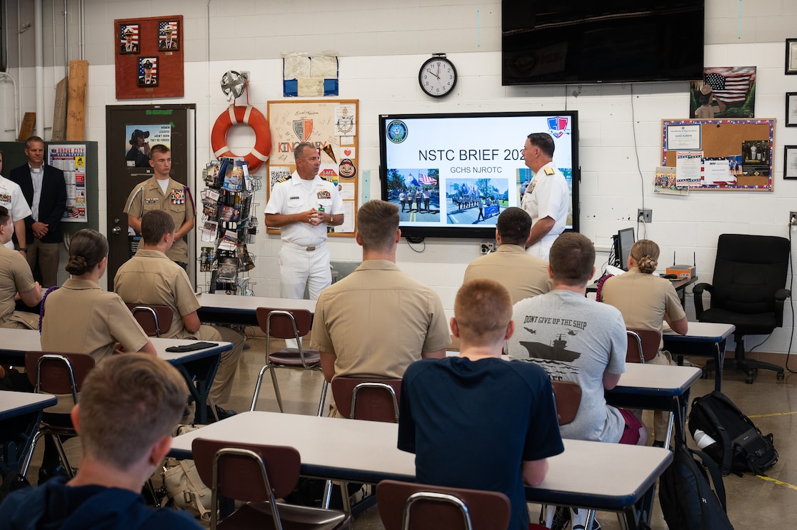 Rear Adm. Matthew Pottenburgh, commander, Naval Service Training Command (NSTC), receives a unit brief from a cadet of Grove City High School Navy Junior Reserve Officers Training Corps (NJROTC), Aug. 22. The engagement was part of Navy Week Columbus to highlight the importance of citizenship, leadership, and service. NSTC, headquartered at Naval Station Great Lakes, Illinois, supports 98 percent of the Navy’s initial officer and enlisted accession training. NSTC oversees Naval Reserve Officers Training Corps programs at more than 160 colleges and universities, Officer Training Command Newport, and Recruit Training Command—the Navy’s only boot camp. NSTC administers the Navy’s citizenship development program, which includes Navy Junior Reserve Officers Training Corps (NJROTC) and the Navy National Defense Cadet Corps, offered at more than 600 high schools worldwide.