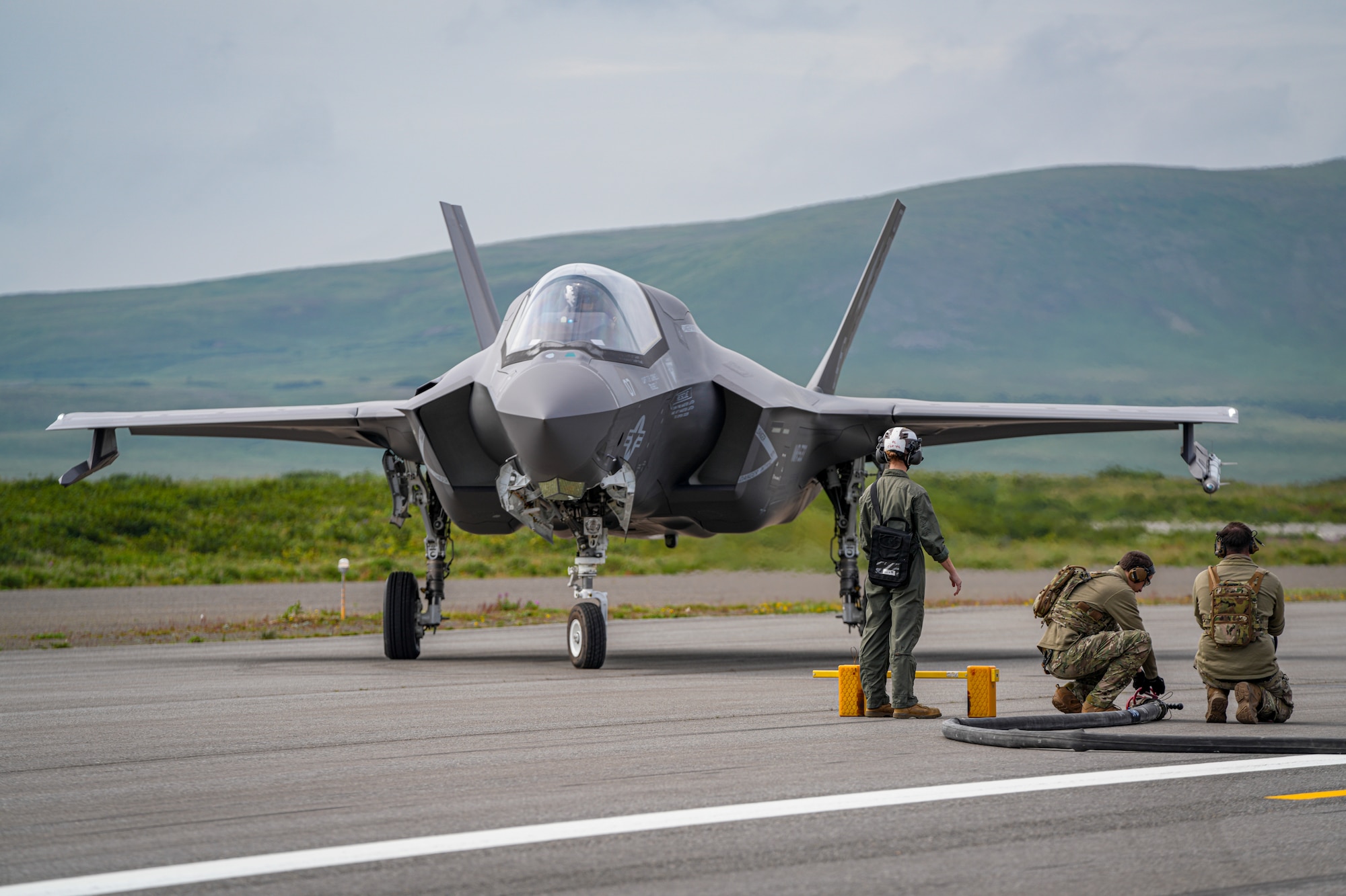U.S. Airmen assigned to the 27th Special Operations Wing perform forward arming and refueling point training (FARP) from an MC-130J Commando II assigned to the 27 SOW to an F-35B Lightning II Joint Strike Fighter assigned to Marine Corps Air Station Beaufort, for ARCTIC EDGE 2025, August 18, 2025, at Cold Bay Airfield, Alaska. AE25 provided Special Operations Command North the opportunity to test a range of capabilities and response options to deter, disrupt, degrade, and deny competitor activity in the Arctic in support of globally integrated layered defense of the homeland. AE25 is a NORAD and U.S. Northern Command-led homeland defense exercise designed to improve readiness, demonstrate capabilities, and enhance Joint and Allied Force interoperability in the Arctic. (U.S. Air Force photo by Airman 1st Class Gracelyn Hess)