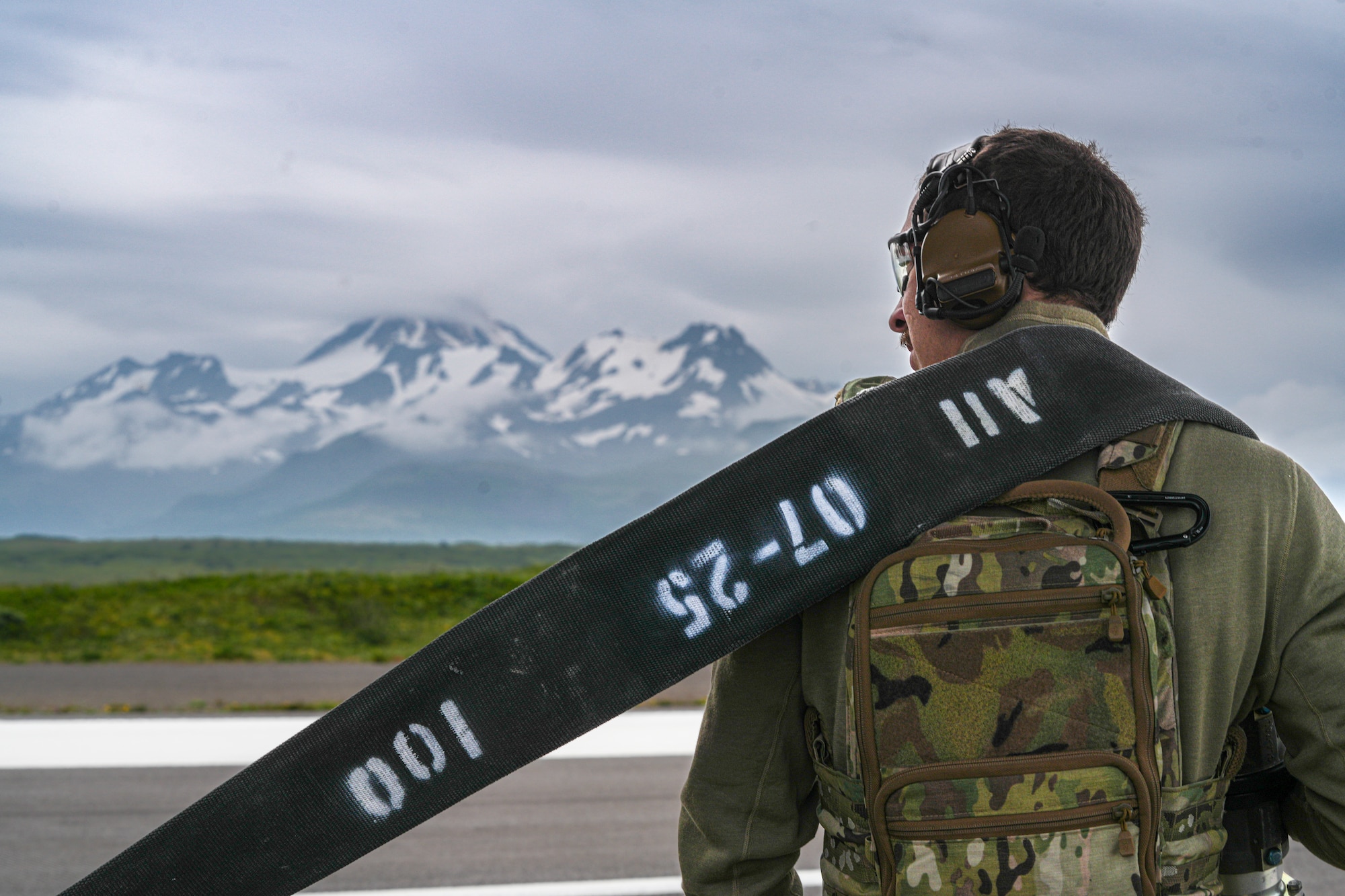 A U.S. Airman assigned to the 27th Special Operations Wing hoists a hose over his shoulder during forward arming and refueling point training (FARP) for ARCTIC EDGE 2025 (AE25) Aug. 18, 2025, at Cold Bay Airfield, Alaska. AE25 provided Special Operations Command North the opportunity to test a range of capabilities and response options to deter, disrupt, degrade, and deny competitor activity in the Arctic in support of globally integrated layered defense of the homeland. AE25 is a NORAD and U.S. Northern Command-led homeland defense exercise designed to improve readiness, demonstrate capabilities, and enhance Joint and Allied Force interoperability in the Arctic. (U.S. Air Force photo by Airman 1st Class Gracelyn Hess)