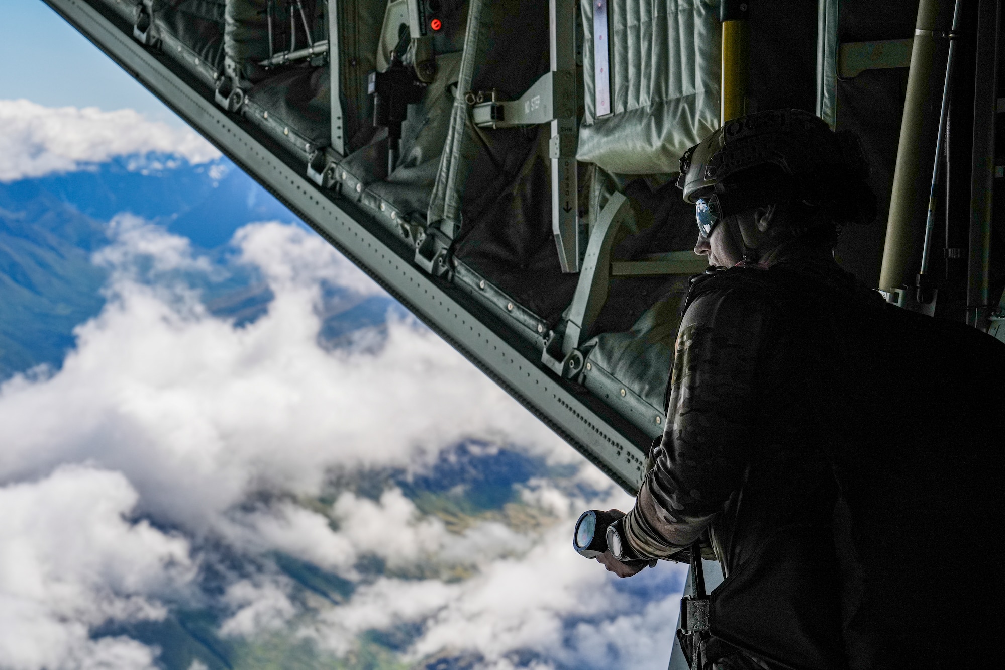U.S. East Coast-based Naval Special Warfare Operators (SEALs) conduct a free fall jump from an MC-130J Commando II assigned to the 27th Special Operations Wing, during ARCTIC EDGE 2025 (AE25) at Joint Base Elmendorf-Richardson, Alaska, Aug. 11, 2025. Specialized training in the Artic environment gives operators real-world experience ensuring continued effective operations in the region. AE25 is a NORAD and U.S. Northern Command-led homeland defense exercise designed to improve readiness, demonstrate capabilities, and enhance Joint and Allied Force interoperability in the Arctic. (U.S. Air Force photo by Airman 1st Class Gracelyn Hess)