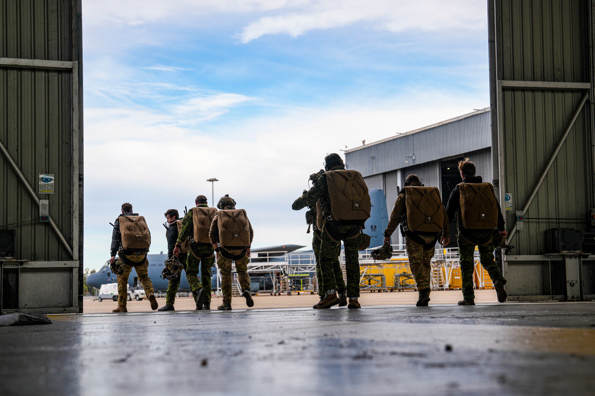 U.S. Air Force Special Tactics Airmen assigned to the 24th Special Operations Wing walk to the flight line to perform a military free fall during exercise Talisman Sabre 2025, July 9, 2025, in New South Wales, Australia. Held across multiple regions in Australia and Papua New Guinea, TS25 is designed to enhance multinational coordination in responding to regional crises and foster peace, stability, and prosperity in the Indo-Pacific. (U.S. Air Force photo by Airman 1st Class Gracelyn Hess)