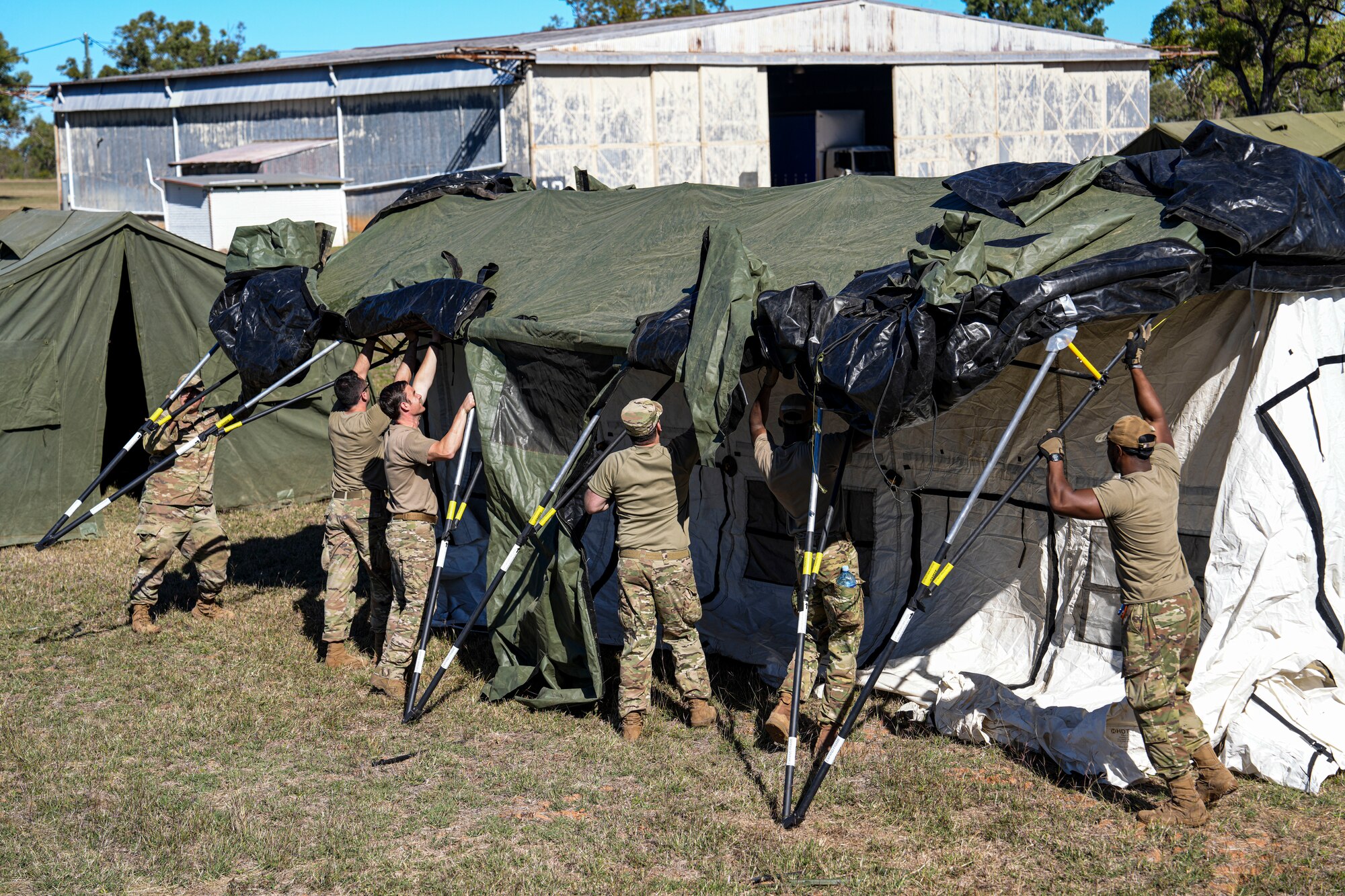 A Mission Sustainment Team assigned to the 27th Special Operations Wing set up a tent for Talisman Sabre operations at Macrossan Training Area, Australia, July 14, 2025. More than 40,000 U.S., Australian, and other international military personnel will participate in TS25, from July to August  2025, around Australia and Papua New Guinea. These events strengthen relationships and interoperability among key allies and partners, enhance our collective capability to respond to a wide array of potential security concerns, and foster peace, stability, and prosperity in the Indo-Pacific. (U.S. Air Force photo by Airman 1st Class Gracelyn Hess)