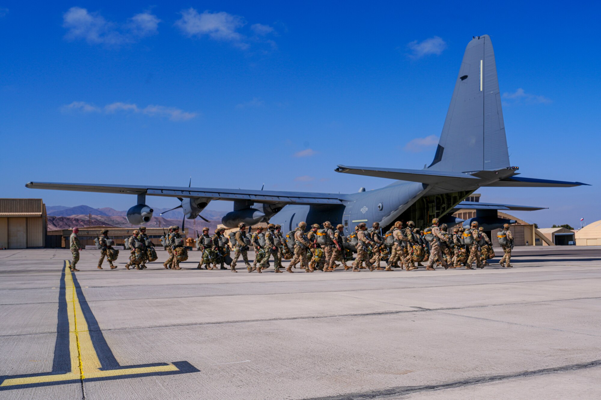 Chilean Paracaidistas begin to board an MC-130 Commando II for a static line jump during SOUTHERN STAR 2025 in Antofagasta, Chile, May 30, 2025. SOUTHERN STAR ‘25 is a multinational special operations exercise is taking place across Chile from May 26 to June 8, uniting forces from six nations and 10 observing countries to enhance interoperability and strengthen global SOF partnerships through joint training from as far north as Antofagasta to the southern region of Punta Arenas. (U.S. Air Force photo by Airman 1st Class Gracelyn Hess)
