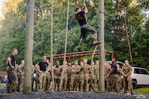 U.S. Marine Corps Gunnery Sgt. Albert Ludwig, a Force Fitness Instructor Trainer with Training Command, demonstrates obstacle course techniques to British Royal Marines as part of “Virginia Tempest” at The Basic School on Marine Corps Base Quantico, Virginia, July 28, 2025. Virginia Tempest is an annual training event where Royal Marines and U.S. Marines collaborate in training such as the obstacle course, Marine Corps Martial Arts Program, and other rigorous events, ultimately designed to support interoperability and maintaining the historic working relationship between the organizations. (U.S. Marine Corps photo by Lance Cpl. Braydon Rogers)