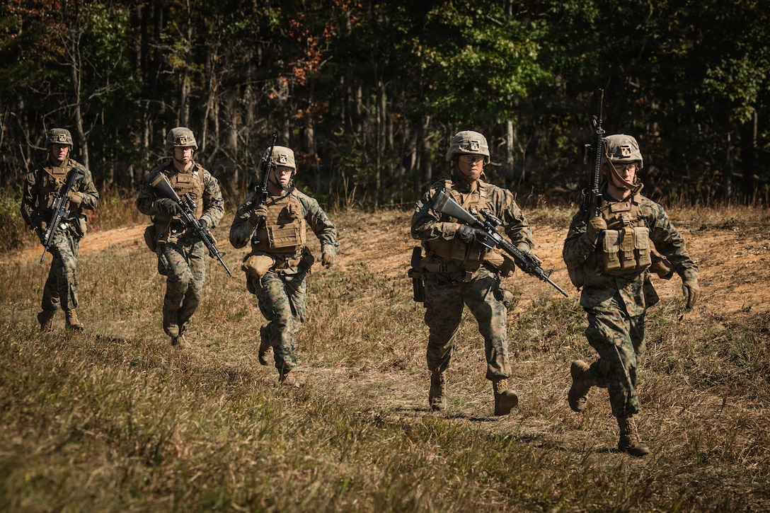 U.S. Marine Corps students with Company D, Basic Officer Course 4-25, The Basic School, run to an objective during a dry-fire run of a Field Firing Exercise on Marine Corps Base Quantico, Virginia, Oct. 10, 2025. The FFEX provided students the opportunity to refine their skills in conducting a live-fire assault on a target with support-by-fire and maneuver elements. (U.S. Marine Corps photo by Cpl. Joshua Barker)