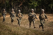 U.S. Marine Corps students with Company D, Basic Officer Course 4-25, The Basic School, run to an objective during a dry-fire run of a Field Firing Exercise on Marine Corps Base Quantico, Virginia, Oct. 10, 2025. The FFEX provided students the opportunity to refine their skills in conducting a live-fire assault on a target with support-by-fire and maneuver elements. (U.S. Marine Corps photo by Cpl. Joshua Barker)