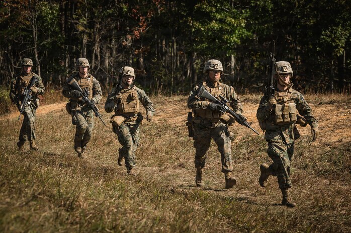U.S. Marine Corps students with Company D, Basic Officer Course 4-25, The Basic School, run to an objective during a dry-fire run of a Field Firing Exercise on Marine Corps Base Quantico, Virginia, Oct. 10, 2025. The FFEX provided students the opportunity to refine their skills in conducting a live-fire assault on a target with support-by-fire and maneuver elements. (U.S. Marine Corps photo by Cpl. Joshua Barker)