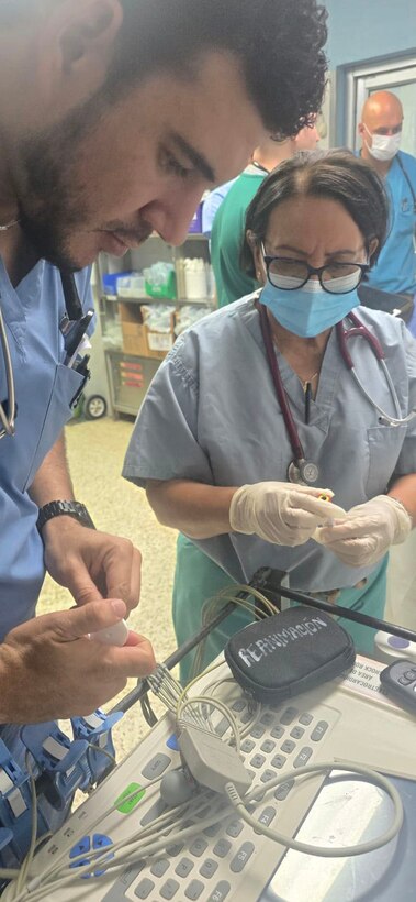 People setting up medical equipment.