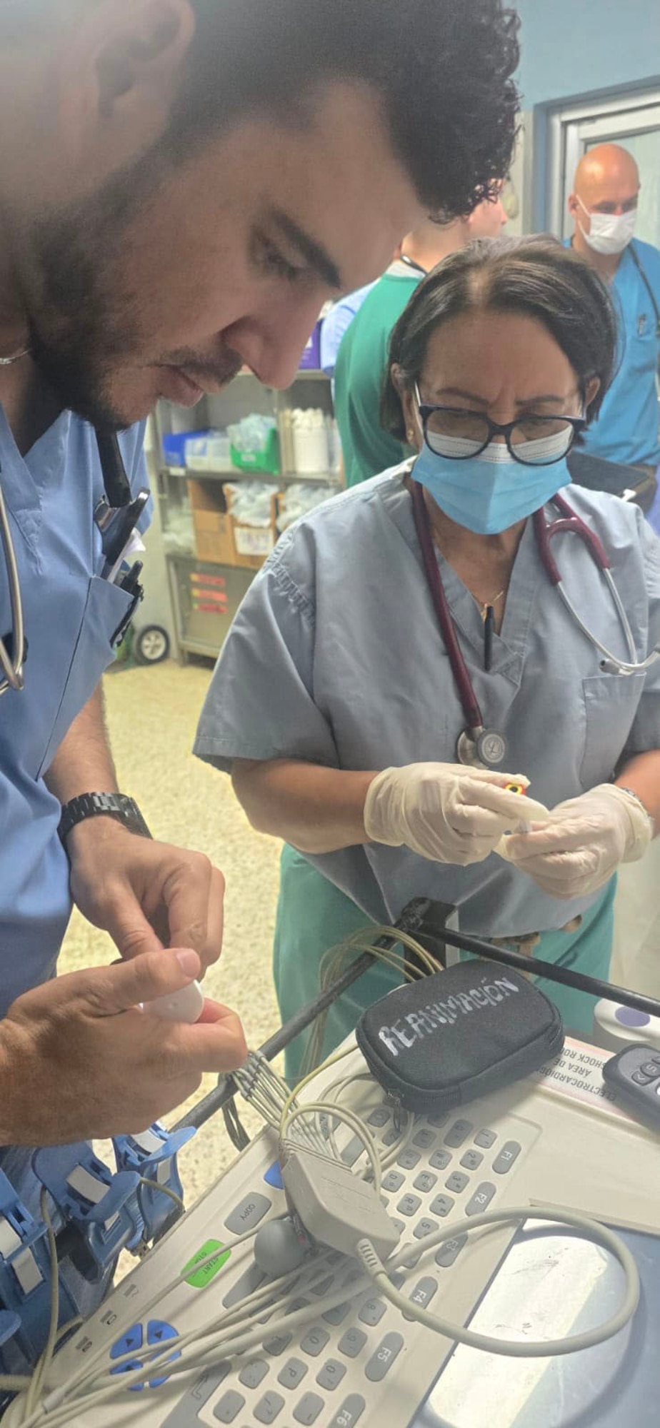People setting up medical equipment.
