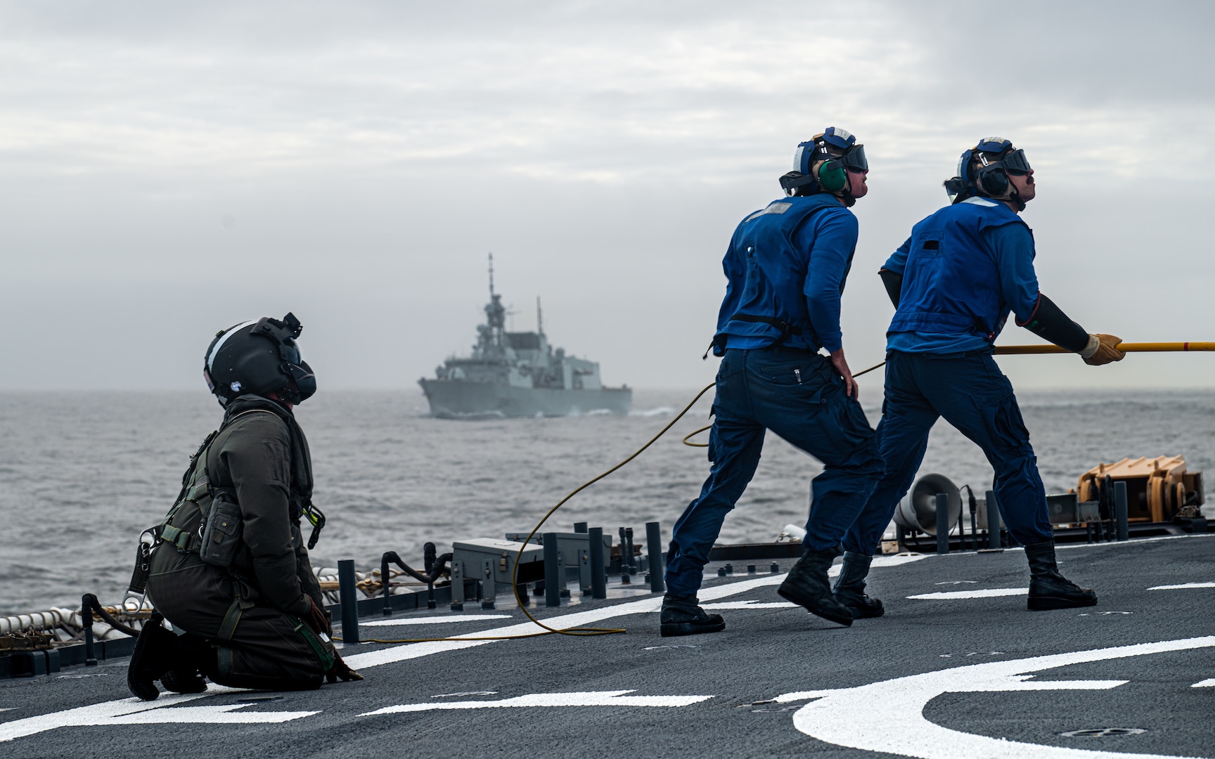 Members of U.S. Coast Guard Cutter Waesche (WMSL 751) and His Majesty's Canadian Ship Regina conduct flight deck training in the Bering Sea, Alaska, Aug. 26, 2025. Candian-led Operation Latitude demonstrates the bilateral and interagency capabilities to detect, eter, and defend North America from adversaries. (U.S. Coast Guard photo by Petty Officer 3rd Class Cameron Snell)