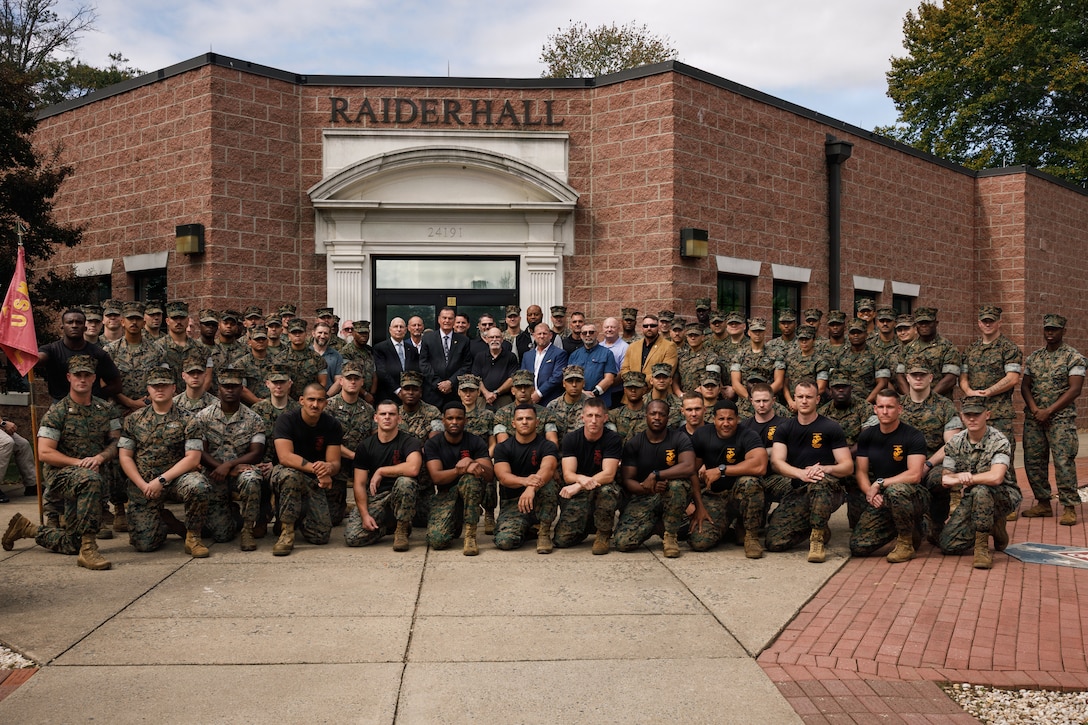 U.S. Marine Corps Ret. Gen. James L. Jones, 32nd Commandant of the Marine Corps, center, Martial Arts Instructor and Instructor Trainers, and former Martial Arts Fitness and Center of Excellence staff pose for a group photo during the Marine Corps Martial Arts 25th anniversary symposium hosted by the MAFCE at Raider Hall on Marine Corps Base Quantico, Virginia, Oct. 8, 2025. The goal of this symposium was to provide the Fleet Marine Force with instructions and practical application on the new tan-black belt syllabus and the new free sparring events while integrating guided discussions fostering character development and recounting the storied tradition of the Marine Corps Martial Arts Program. (U.S. Marine Corps photo by Cpl. Joshua Barker)