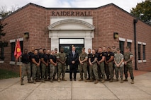 U.S. Marine Corps Ret. Gen. James L. Jones, 32nd Commandant of the Marine Corps, center, and Marines with the Martial Arts and Fitness Center of Excellence pose for a photo during the Marine Corps Martial Arts 25th anniversary symposium hosted by the MAFCE at Raider Hall on Marine Corps Base Quantico, Virginia, Oct. 8, 2025. The goal of this symposium was to provide the Fleet Marine Force with instructions and practical application on the new tan-black belt syllabus and the new free sparring events while integrating guided discussions fostering character development and recounting the storied tradition of the Marine Corps Martial Arts Program. (U.S. Marine Corps photo by Cpl. Joshua Barker)