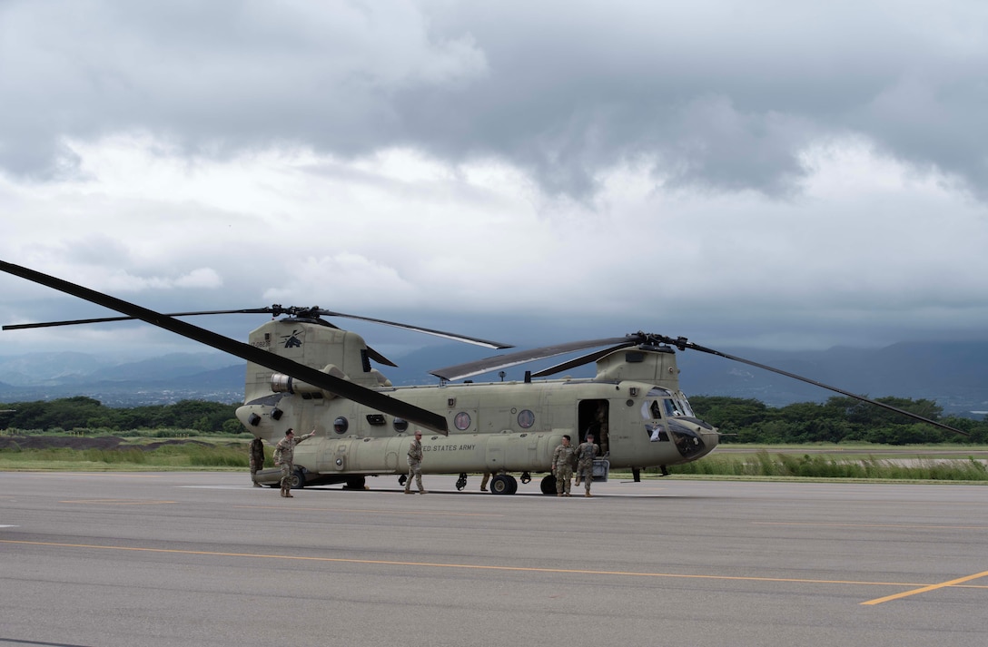 Servicemembers board a helicopter