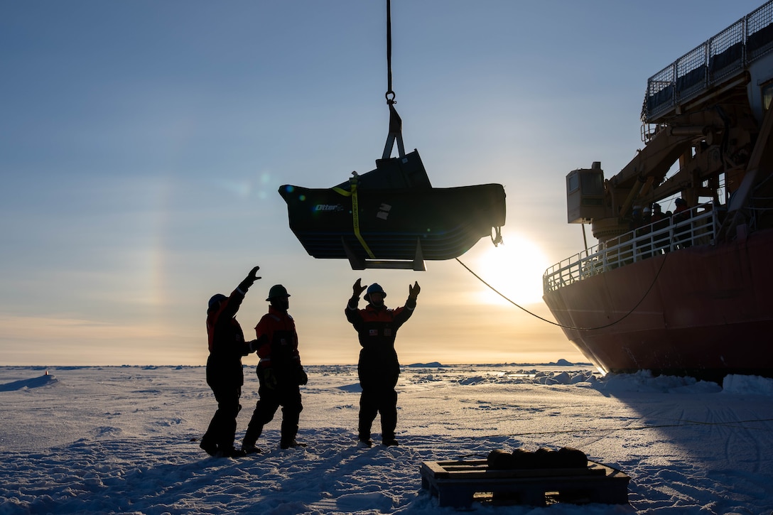 U.S. Coast Guard Cutter Healy (WAGB 20) crewmembers lower instrumentation onto the ice in the Arctic Ocean, Oct. 1, 2025. Coast Guard operations in the Arctic are critical to expanding our understanding of the Arctic operating environment for advancing national security objectives. (U.S. Coast Guard photo by Petty Officer 3rd Class Chris Sappey)