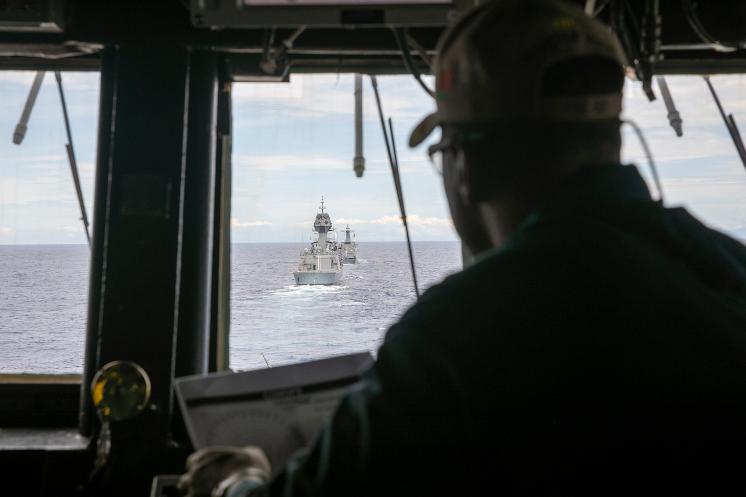 Cmdr. Paul Richardson, commanding officer of Arleigh Burke-class guided-missile destroyer USS Fitzgerald (DDG 62), observes Philippine Navy Jose Rizal-class guided-missile frigate BRP Jose Rizal (FF-150) and Royal Australian Navy Anzac-class frigate HMAS Ballarat (FFH 155) while sail in formation with Fitzgerald during a maritime cooperative activity (MCA) in the Philippines’ exclusive economic zone (EEZ), Oct. 31, 2025.