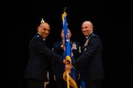 U.S. Air Force Lt. Gen. Brian S. Robinson, outgoing commander, Air Education Training Command, presents the guidon to incoming commander, Lt. Gen. Clark J. Quinn during AETC's change of command ceremony at Joint Base San Antonio - Randolph, Texas, Oct. 31, 2025. Quinn is the 36th AETC commander and is now responsible for a command that includes Air Force Accessions Center, two Numbered Air Forces, and Air University training more than 293,000 students per year with approximately 60,000 active duty, Reserve, Guard and contractor personnel. (U.S. Air Force photo by Tech. Sgt. Amy Younger)