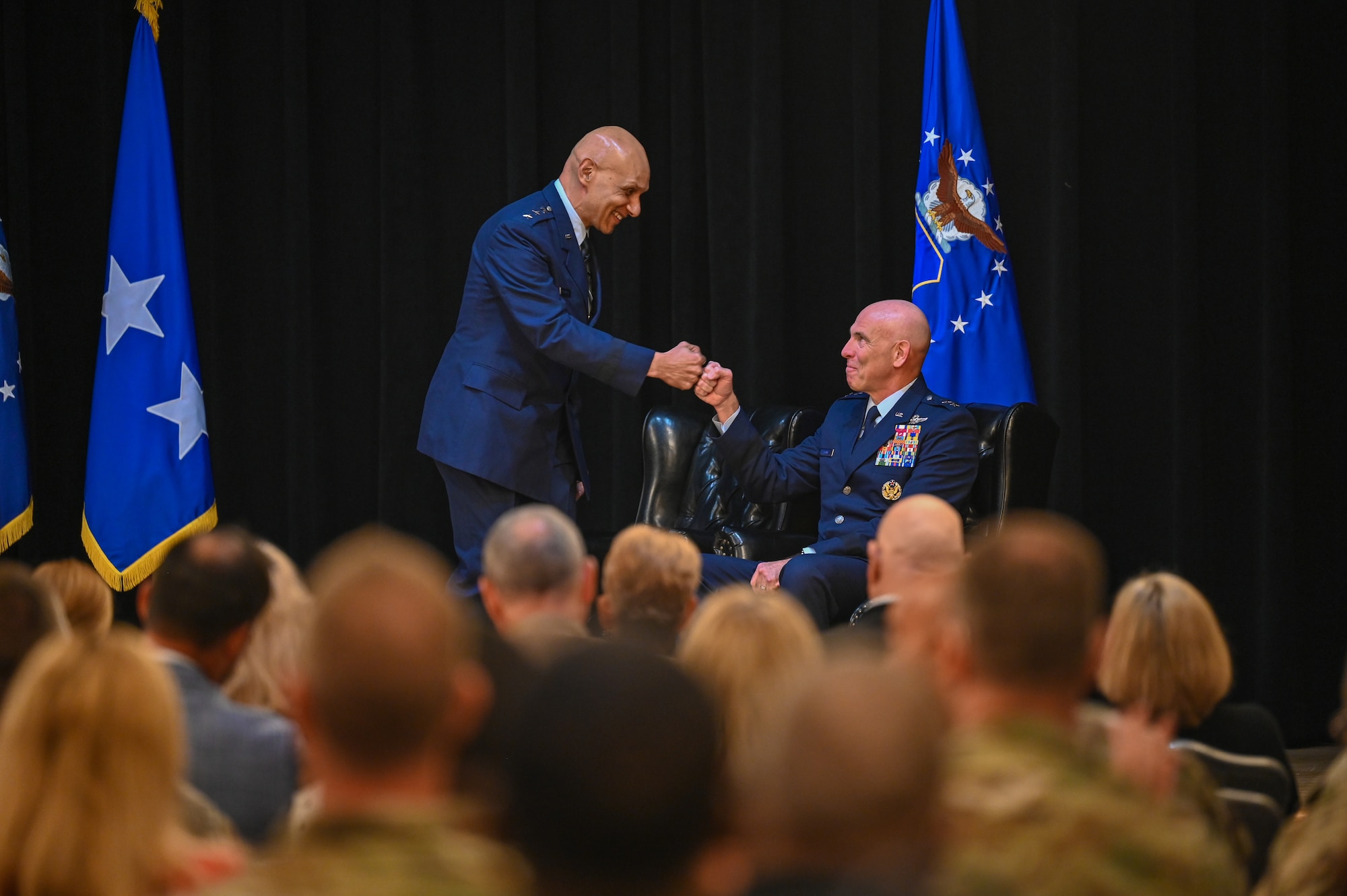 U.S. Air Force Lt. Gen. Brian S. Robinson, outgoing commander, Air Education Training Command, congratulates incoming commander, Lt. Gen. Clark J. Quinn during AETC's change of command ceremony at Joint Base San Antonio - Randolph, Texas, Oct. 31, 2025. Quinn is the 36th AETC commander and is now responsible for a command that includes Air Force Accessions Center, two Numbered Air Forces, and Air University training more than 293,000 students per year with approximately 60,000 active duty, Reserve, Guard and contractor personnel.