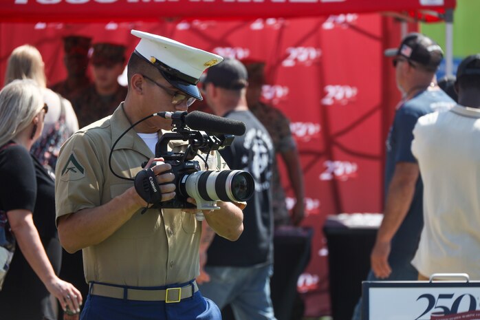 U.S. Marine Corps Lance Cpl. Elijua Guel, combat videographer, captures video footage during Marine Week Atlanta in Atlanta, Ga., Aug. 31, 2025. The year 2025 marks the 250th anniversary of the United States Marine Corps, a milestone that highlights the legacy, transformation and enduring spirit of the Corps since 1775. Throughout the year, Marines across the globe will commemorate this anniversary by honoring the service and sacrifice of those who served before them and by remaining faithful to the motto Semper Fidelis. (U.S. Marine Corps photo by Cpl. Christopher Prelle)
